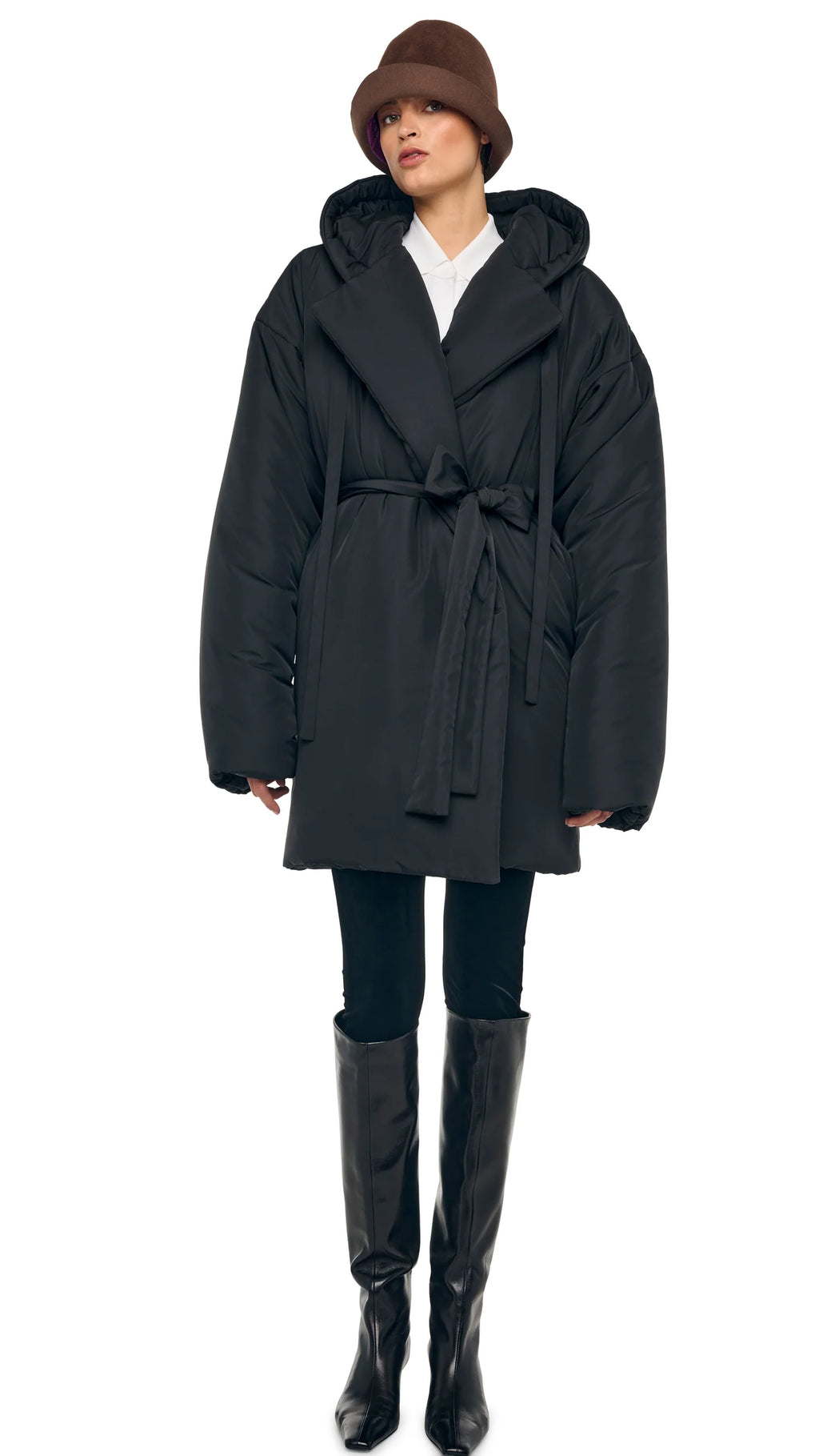 Model wearing Norma Kamali oversized hooded Sleeping Bag Coat to knee length with drawstring belt