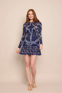 Cara Cara Viola Dress – long-sleeve printed mini dress with smocked front panel, ruffle details, and side pockets