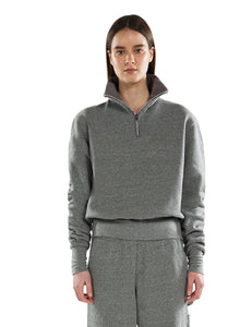 Cropped half-zip pullover with banded hem, made from a soft blend of rayon, polyester, cotton, and spandex. Features a relaxed fit and a trendy athletic style.