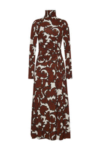 A long sleeve, turtleneck midi dress with an asymmetric draped paneled bodice, ruched at the waist for a flattering fit-and-flare silhouette. Features lean sleeves, a center back seam with hidden zipper and hook-and-eye closure, and an allover print. Unlined for a sleek look.