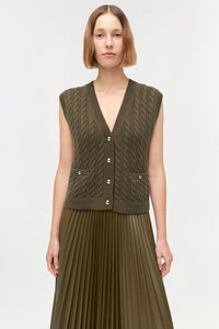 Model wearing Simkhai Perrie Cashmere Vest in olive with cable knit texture and gold-tone buttons
