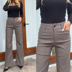 Close-up of Bevy Flog Amy pants elastic waistband with belt loops and button-zipper closure