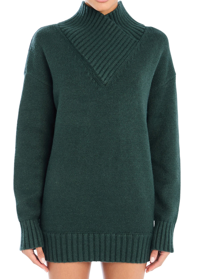 Model wearing Seroya Dessa Chunky Knit Sweater Dress in Evergreen – oversized chunky knit with high neck, styled as a dress.