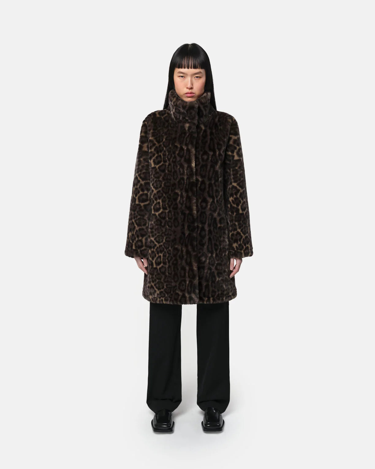 Woman wearing Apparis Balire Leopard Coat with leopard print, relaxed fit, stand collar, and snap closure; eco-friendly faux fur outerwear made from recycled polyester
