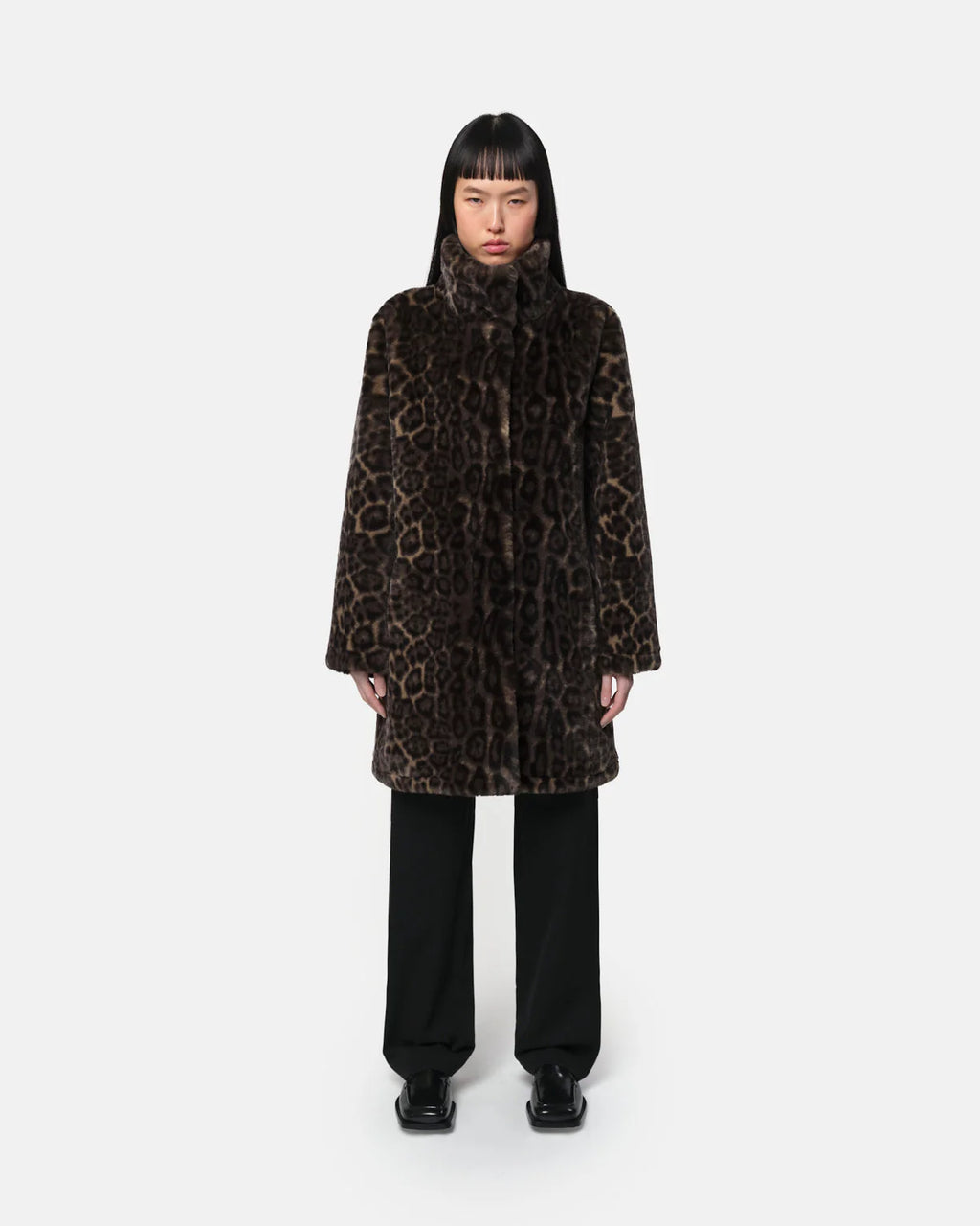 Woman wearing Apparis Balire Leopard Coat with leopard print, relaxed fit, stand collar, and snap closure; eco-friendly faux fur outerwear made from recycled polyester