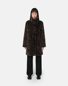 Woman wearing Apparis Balire Leopard Coat with leopard print, relaxed fit, stand collar, and snap closure; eco-friendly faux fur outerwear made from recycled polyester