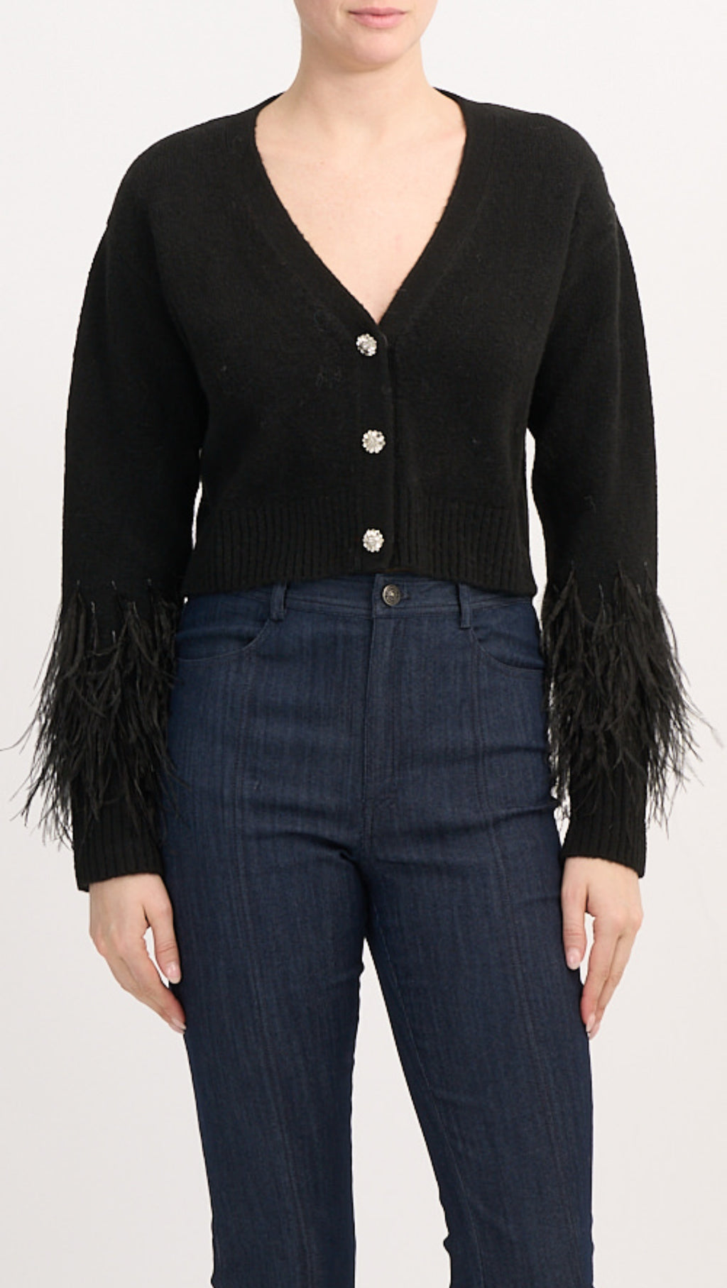 Cropped V-neck cardigan with button front, heather knit body, and dramatic feather-trimmed cuffs, made from soft stretch acrylic blend.