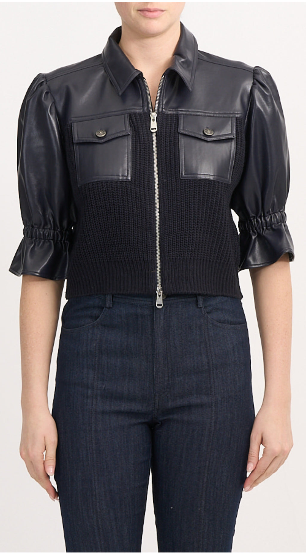 Women’s knit combo jacket with tailored collar, front closure, and pocket detailing, blending structured design with soft knit texture.