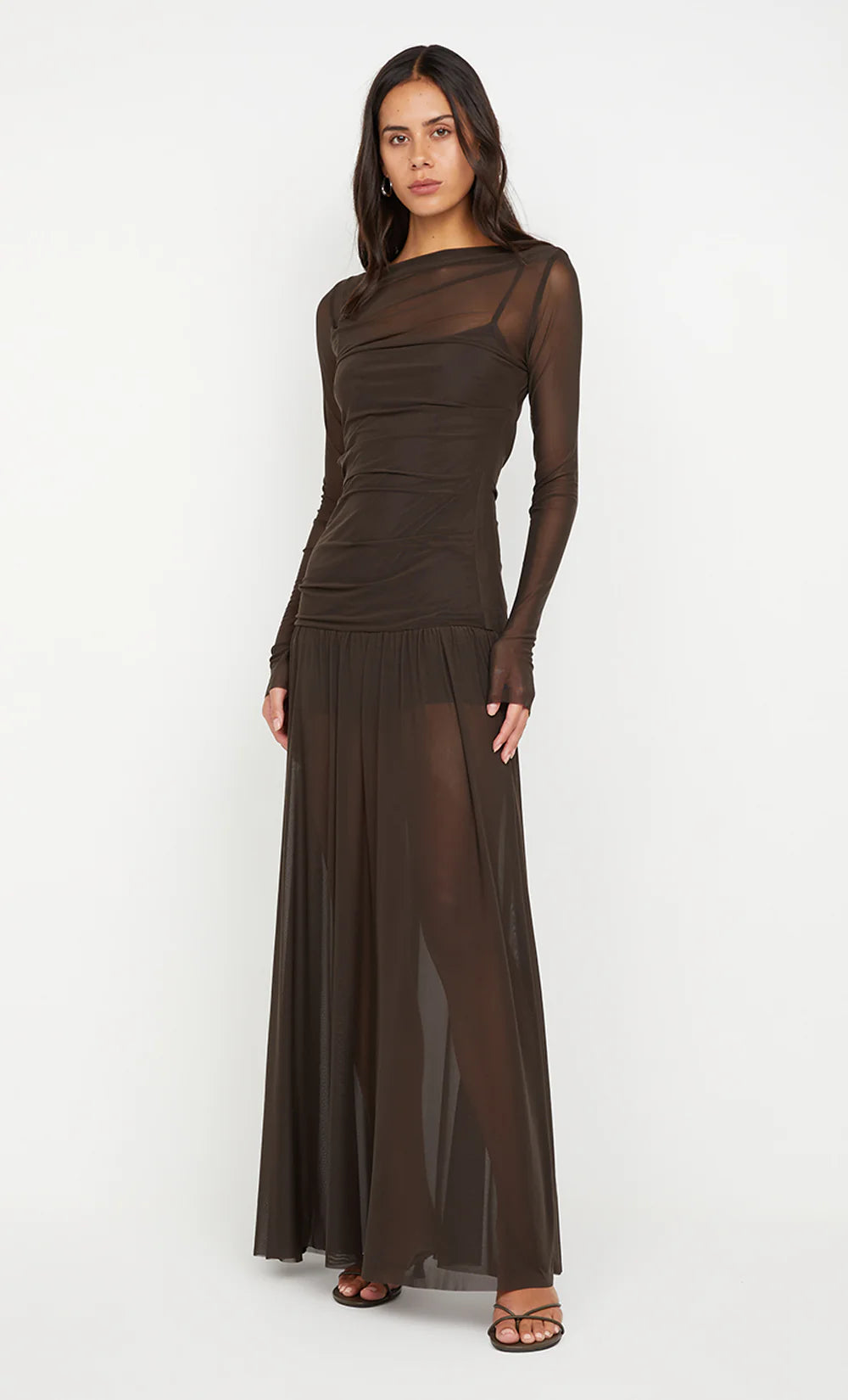 Model wearing the Bec + Bridge Blaine long sleeve maxi dress in a sleek, body-hugging silhouette with full-length sleeves and minimalist design