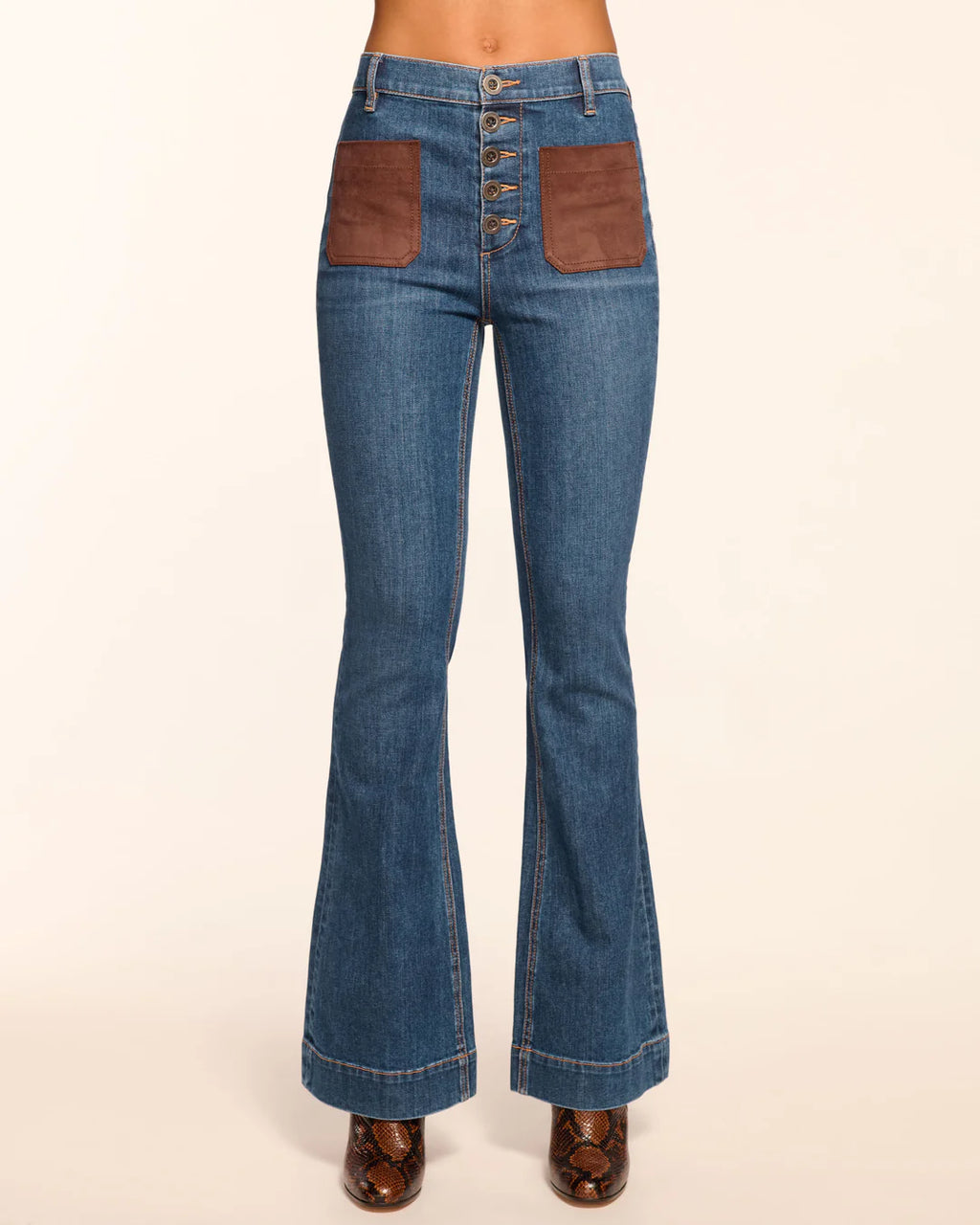 Ramy Brook Cindy women’s high-rise flare jeans with faux suede patch pockets, five-button fly, and stretch cotton fabric.