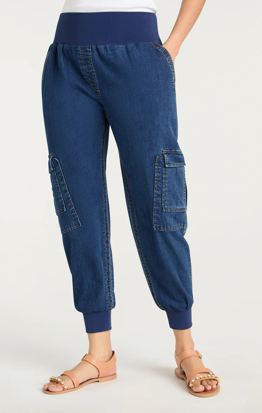 Model wearing the Cinq à Sept Denim Giles Pant in soft blue Tencel denim, featuring a mid-rise waist, cropped jogger silhouette, and side pockets