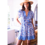 Load image into Gallery viewer, Hand-block printed Bell Kerri mini dress in silk cotton voile featuring a V-neckline, double ruffle sleeves, and an adjustable drawstring waist.
