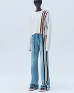 Load image into Gallery viewer, Model wearing Hellessy Karsh denim boyfriend jeans in medium blue wash, featuring relaxed fit, subtle grosgrain application detailing, mid-rise waist, and full-length straight leg silhouette
