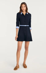 Load image into Gallery viewer, Model wearing the Cinq à Sept Stripe Shirting Lucilla Dress, a striped mini shirt dress with contrast trim at the collar and cuffs, button-front closure, scrunched three-quarter sleeves, pleated skirt, and a slim adjustable belt defining the waist
