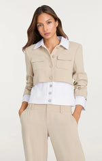 Load image into Gallery viewer, Model wearing the Cinq à Sept Denim Lorraine Jacket, a mixed media jean-style jacket with a collared neckline, button-up front, contrast trim at the collar, cuffs, and waist, gathered three-quarter sleeves, and front flap pockets.
