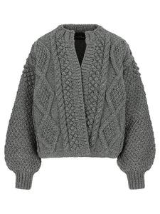 A soft, 100% wool cardigan featuring a unique stitching pattern and round neckline. The Kimmie Cardigan has an above-the-hips length and an open design without closures, offering a relaxed, effortless fit. Perfect for layering over any outfit, it combines timeless style with a contemporary silhouette